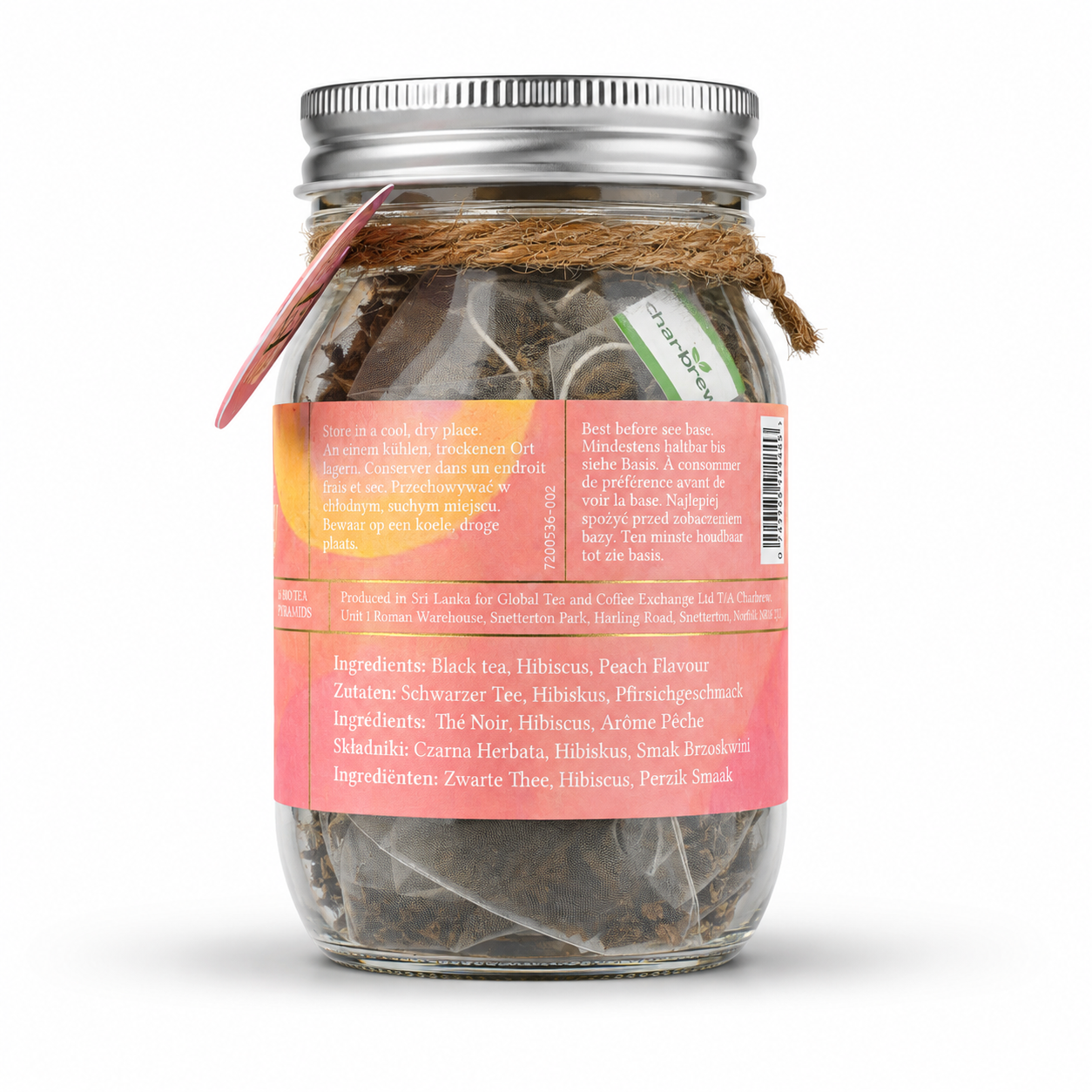 A glass mason jar filled with peach cold brew teabags, featuring a pink label with gold lettering, a silver metal lid, and a pink circular tag on the side. perfect for picnics, alfresco dining, dinner and garden parties, gifts , non alcoholic summer alternative.